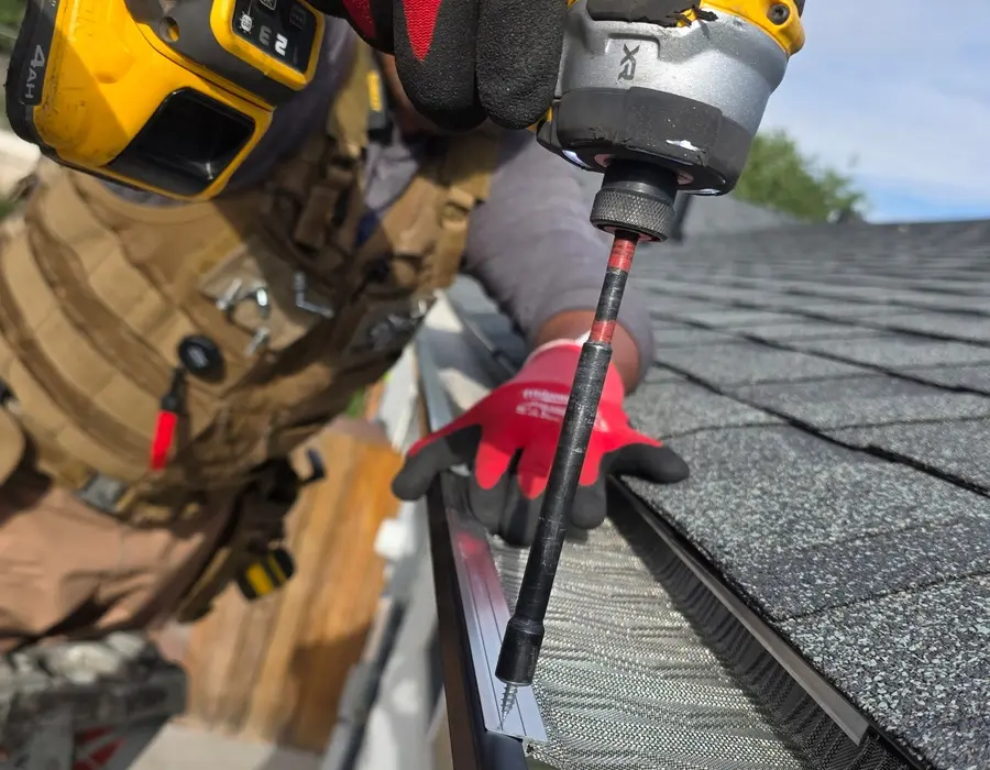 Fastening a drip edge with a drill during a roof repair