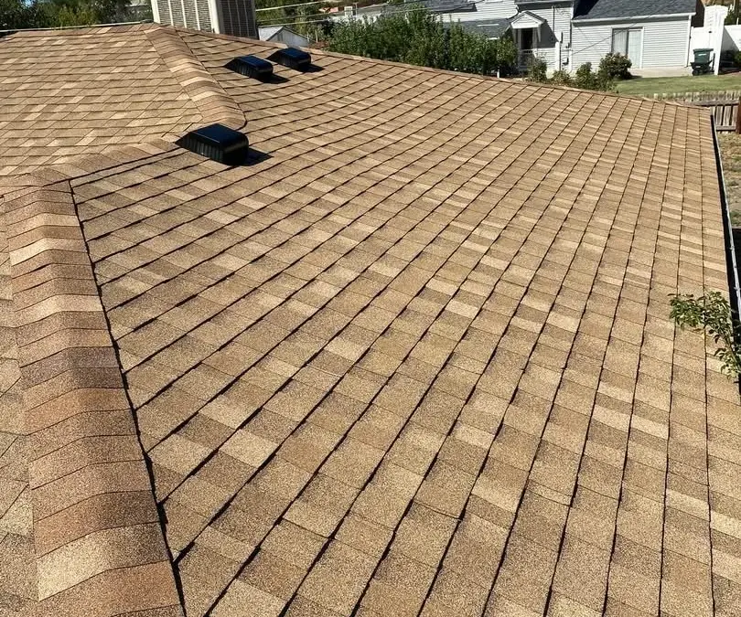 Tan architectural shingles installed by Denali Roofing on a Utah home