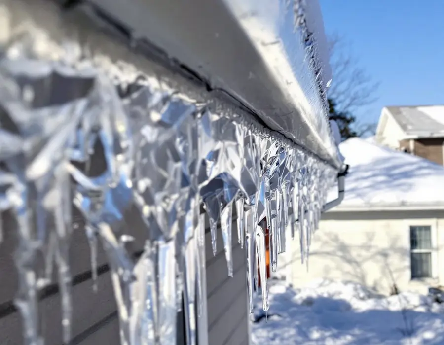Ice built up along the eave of a shaded north-facing slope