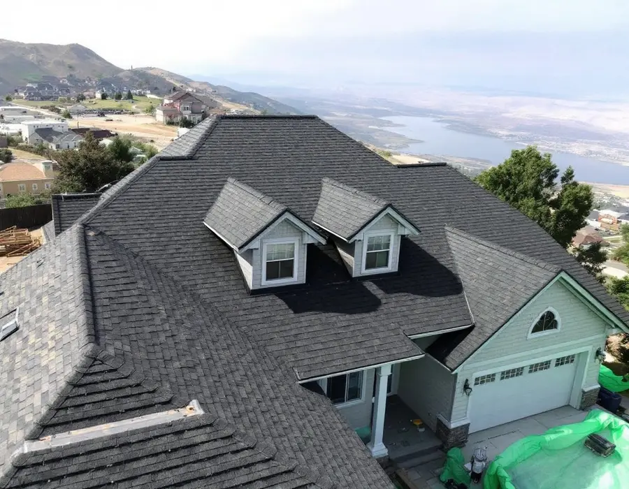 Complex bench roofline with dormers, hips and valleys under new shingles