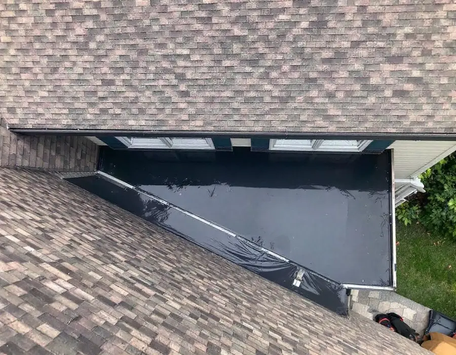 Low-slope porch membrane meeting the steep shingled main roof