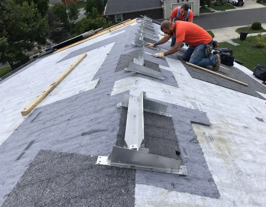 New underlayment down with a row of new flashed solar mounts set, shingles going on around them